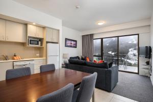 a kitchen and living room with a table and chairs at Lantern 24 Balcony in Thredbo