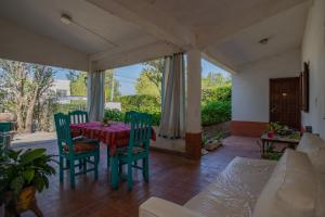a dining room with a table and chairs and a couch at San Lorenzo ByB in San Lorenzo