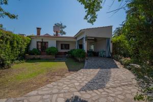 a house with a stone walkway in front of it at San Lorenzo ByB in San Lorenzo