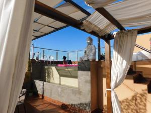 a statue sitting on top of a building with a roof at Rincón de Paz Apart & Loft Suite Boutique - Adults Only in Villa Carlos Paz +38 photos