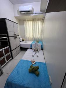 a small room with a bed and a stuffed animal at Staycation Studio at Green Residences in Manila