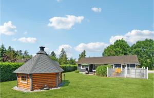 eine Blockhütte im Hof eines Hauses in der Unterkunft Amazing Home In rsted With Kitchen in Ørsted