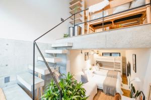 a bedroom in a loft conversion with a bed and stairs at RiriLeo Koenji in Tokyo