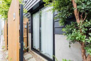 a house with black siding and a window at RiriLeo Koenji in Tokyo