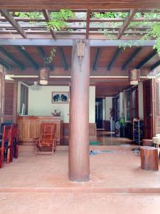 a pavilion with a pole in the middle of a patio at 遗忘时光Guesthouse Sky dragon Guesthouse in Luang Prabang