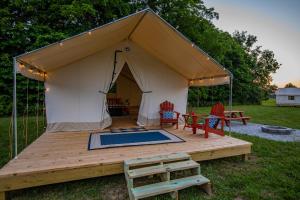 a tent with a swimming pool in a yard at Yellowstone Glamping Tent in Cassville