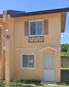 a house with a door and a window and a fence at Camella Staycation in Butuan