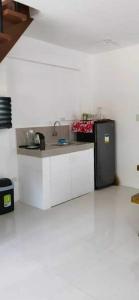 a kitchen with a sink and a refrigerator at Camella Staycation in Butuan