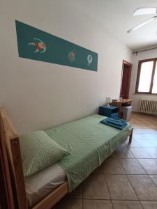 a bedroom with a bed with a green comforter at Magnolia B&B in Silvi Marina