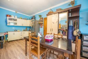 a kitchen with a dining room table and chairs at MTASHI - მთაში in Ushguli +37 photos