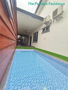 a swimming pool in the backyard of a house at The Pandan Residence in Kuantan