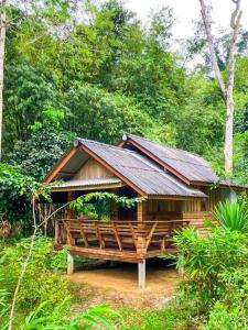a wooden cabin in the middle of a forest at Toh Tao Homestay 