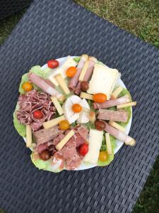a plate of food on a picnic table at Gîte Les Galipes in Mareuil-sur-Ay