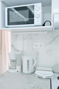 a microwave sitting on top of a kitchen counter at Niko's Apartment - Beautiful Sea Apartment ! in Perea