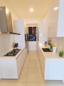 a kitchen with white counters and a stove top oven at Rooftop Pool, 8 Pax, 2 Bedrooms, 2 Bathrooms, 2 Car Parks by Star Home in Jelutong