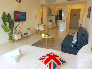 a room with a bed and a living room at Rooftop Pool, 8 Pax, 2 Bedrooms, 2 Bathrooms, 2 Car Parks by Star Home in Jelutong