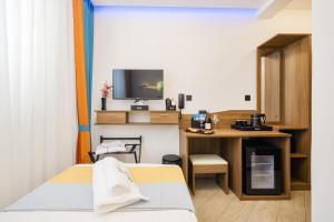 a room with a bed and a desk and a tv at Hotel Kanjon Zrmanje in Obrovac