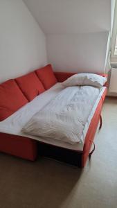 a bed in a room with a red frame at M-Hostel in Lucerne