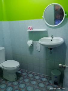 a bathroom with a toilet and a sink and a mirror at SK Hometel Samui Airport in Bangrak Beach