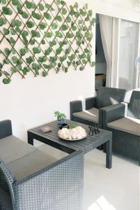 a living room with two chairs and a table at Niko's Apartment - Beautiful Sea Apartment ! in Perea