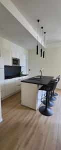 a kitchen with a black table and chairs in a room at Apartment on the sea in Opatija