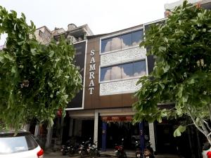 a building with trees in front of it at OYO Hotel Samrat in Kānpur
