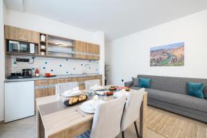 a kitchen and living room with a table and a couch at Hotel Kanjon Zrmanje in Obrovac