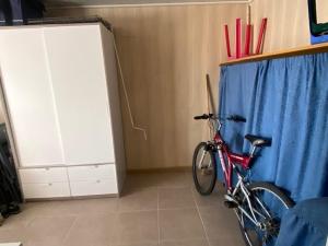 uma bicicleta estacionada num quarto com uma cortina azul em Camping Esmeralda em De Haan