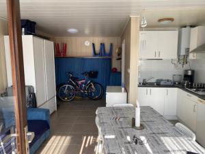 a kitchen with a bike in the middle of a room at Camping Esmeralda in De Haan