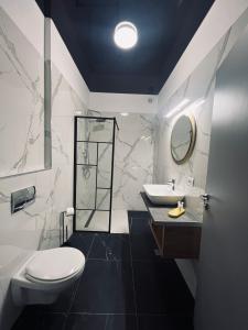 a bathroom with a toilet and a sink at Apartaments PopDan Residence by the Sea in Eforie Nord