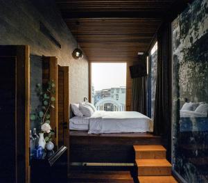 a bedroom with a bed on a balcony at Na Tanao 1969 in Bangkok