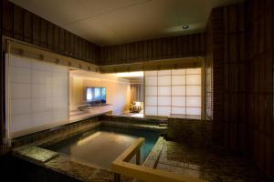 una gran piscina de agua en una habitación con baño en Hotel Yuraku Kyo-yasaka en Giommachi