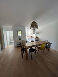 a dining room with a wooden table and chairs at Superbe appartement bord de mer in Saint-Mandrier-sur-Mer