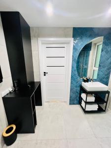 a bathroom with a white door and a sink at SunBaltic Premium Ustka, II Poziomy, Przy Lesie, Dwa Balkony, Klimatyzacja, Parking in Ustka