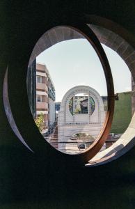 a view of a building through a circular window at Na Tanao 1969 in Bangkok