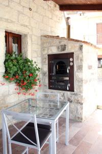 a glass table in front of a stone fireplace at b&b Torrepalazzo in Torrecuso