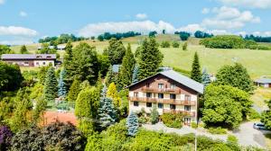 an aerial view of a house in the middle of trees at Pension Imlauf in Vrchlabí