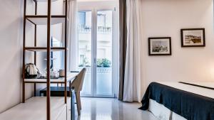 a bedroom with a bed and a desk with a table at Kalista in Cagliari
