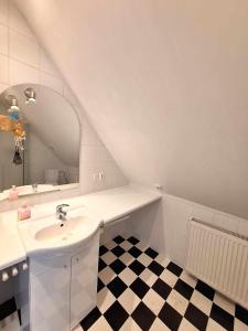 a white bathroom with a sink and a mirror at Michałowa Zagroda in Piechowice