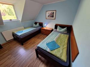 Un pat sau paturi într-o cameră la Michałowa Zagroda