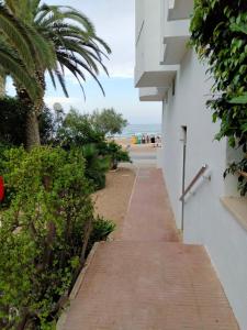 a walkway leading to the beach from a building at Margaritas in Alcossebre