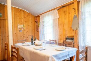 a dining room with a table with a white table cloth at GuestHouse NaSHGOBI in Ushguli