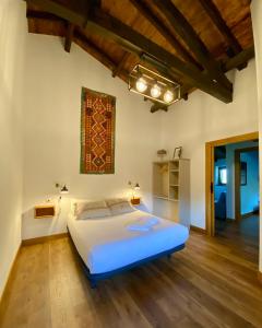 una camera con un grande letto e pavimenti in legno di Bidegurutzeta landetxea a Urnieta