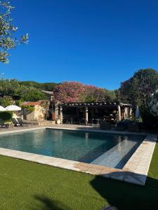 a swimming pool in the middle of a yard at Auberge de l'Oumède in Saint-Tropez