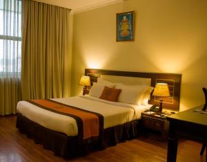 a hotel room with a large bed and two lamps at Vannasut Hotel and Spa in Kathmandu