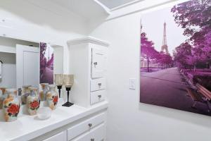 a white room with a picture of the eiffel tower at Metro Paris - 3 Day Minimum - Secluded Studio near the Long Beach Harbor in Long Beach