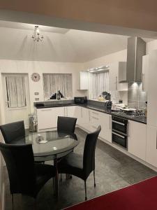 a kitchen with a table and chairs in it at Lovely Calm Independent Home in Belvedere