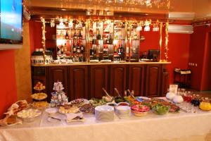 a table with a buffet of food on it at Hotel Aristokrat Kostroma in Kostroma