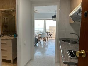 a kitchen and dining room with a view of the ocean at Suites Alicante in Alicante