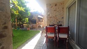 a patio with chairs and a yard with a house at Sea Soul in Artemida